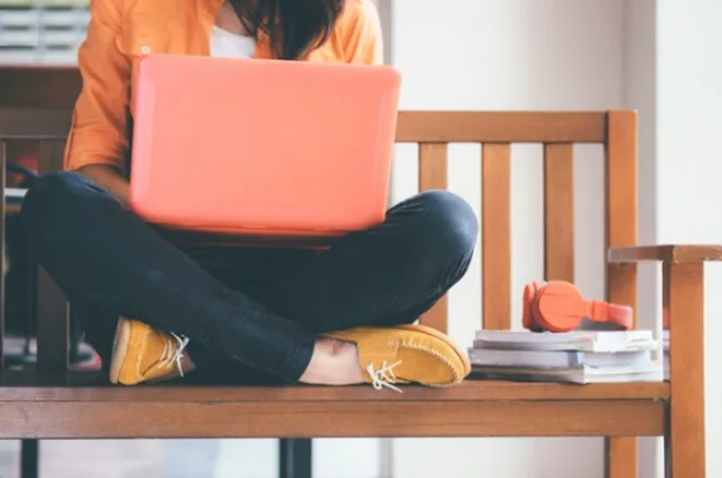 A girl leaning on laptop.
